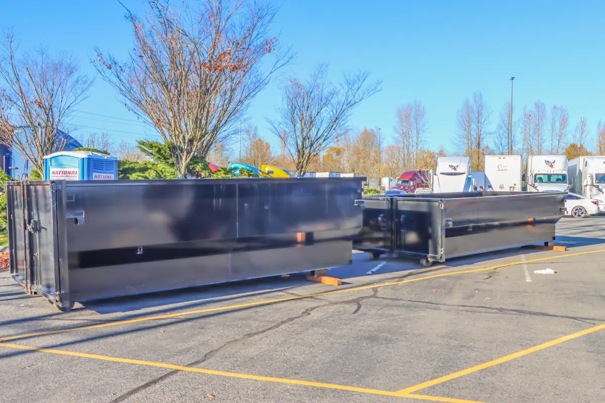 Professional dumpster rental service with roll-off container on residential driveway in Firestone